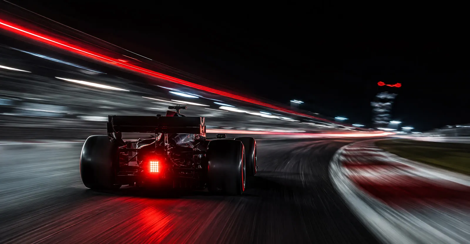 Formula 1 car at speed with light trails